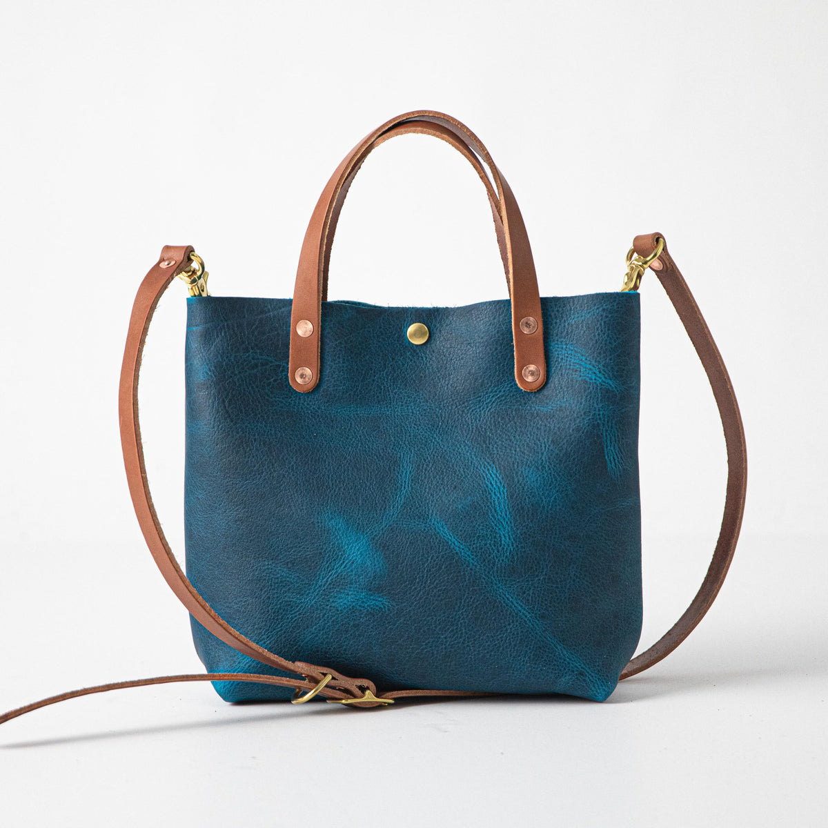 Vibrant Petrol Blue Bison Mini Tote, handmade with full-grain leather, tan handles, and a detachable strap.