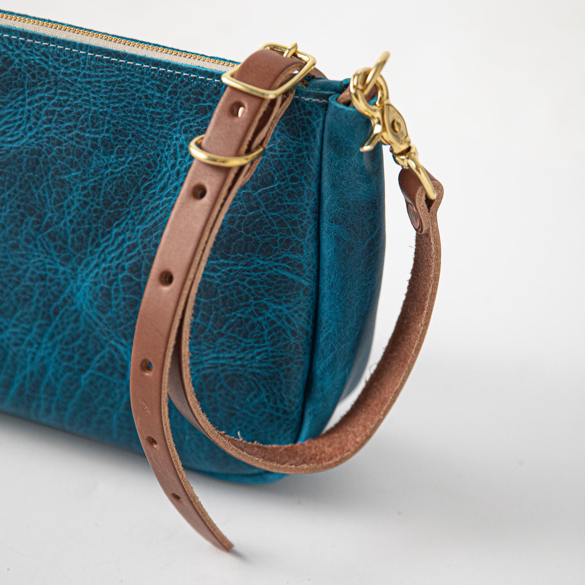 Petrol Blue Bison Crossbody Bag, handmade full-grain leather with brass hardware and brown leather strap.