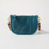Petrol blue full-grain leather mini crossbody bag with solid brass hardware and a secure top zipper.
