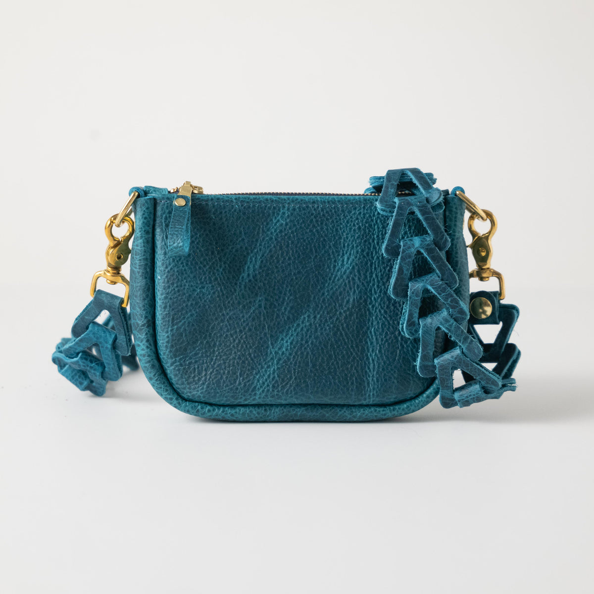 Petrol blue full-grain leather mini crossbody bag with a unique chain-link strap and polished solid brass hardware.