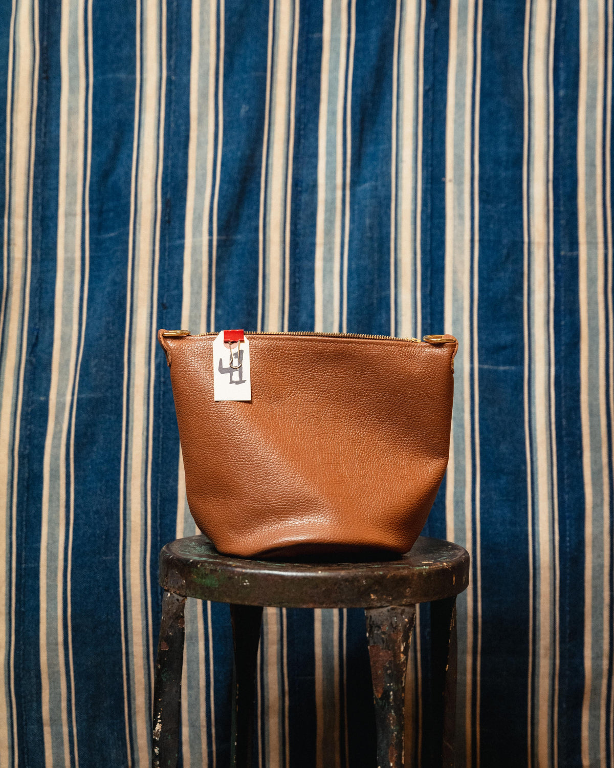 41. Cognac Italian Pebbled Mini Zip Top Bucket Bag