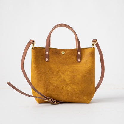 Vibrant Yellow Bison full-grain leather mini tote with tan handles and a detachable shoulder strap.