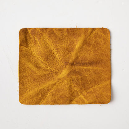 Vibrant Yellow Bison full-grain leather swatch, showcasing its prominent grain and soft temper.
