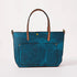 Handmade petrol blue bison leather east-west travel tote with tan handles and a spacious front pocket.