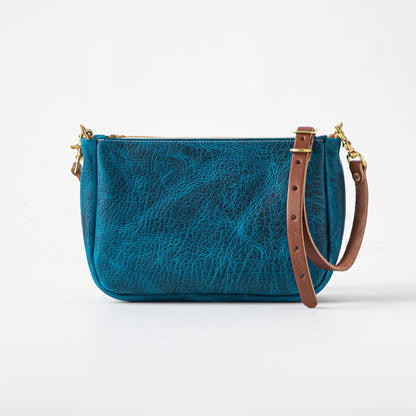 Petrol Blue Bison Crossbody Bag: full-grain leather, solid brass zipper, and brown leather strap.