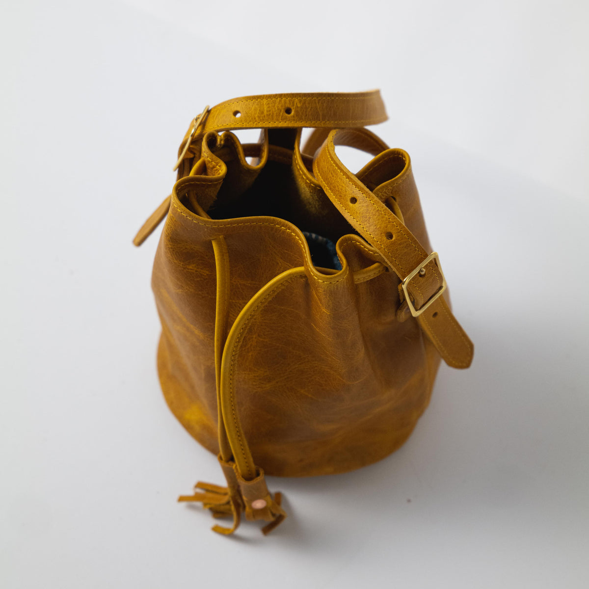 Heirloom-quality Yellow Bison Bucket Bag, handmade of full-grain yellow leather with prominent grain and soft temper.