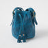 Petrol Blue Bison Bucket Bag: textured leather, drawstring closure with playful tassels, adjustable strap, brass hardware.